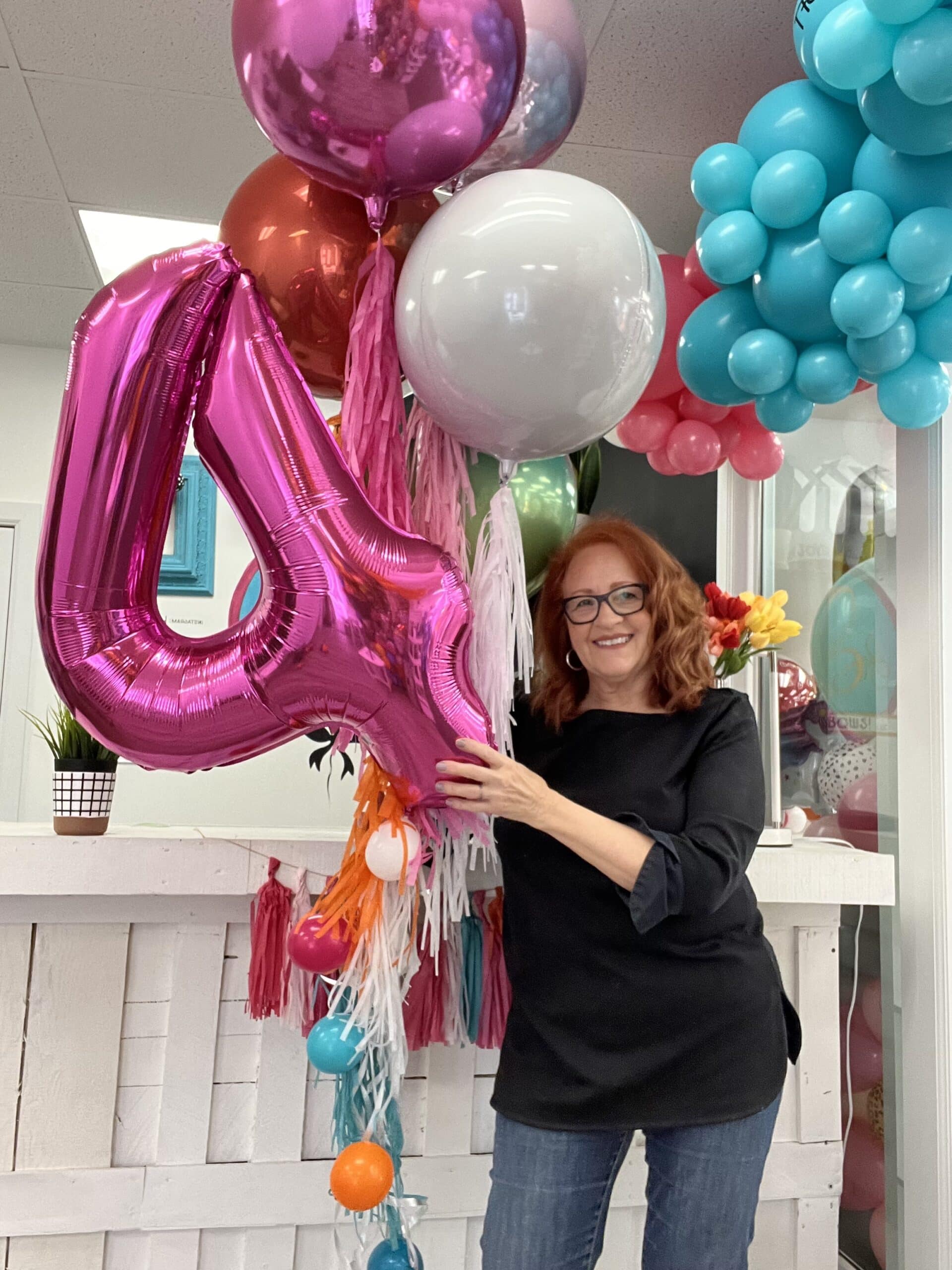 owner holding balloons